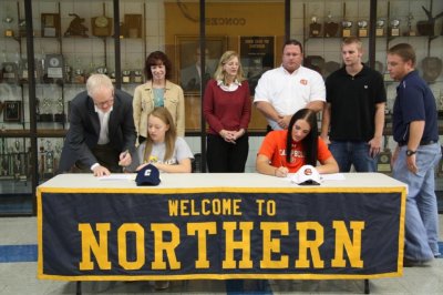 Kailey Farmer signing w pen in hand.jpg